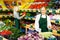 Smiling salesgirl offering fruits and vegetables in family shop