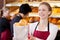 Smiling saleswoman in bakery