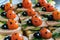 Smiling sandwiches with edible ladybugs from tomatos and olives, as well as bread, cheese, cucumber, sausage, dill