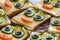 Smiling sandwiches with face from cucumbers, tomato, olive and dill