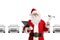 Smiling Santa Claus in a car showroom holding a clipboard and car repair tools