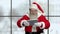 Smiling Santa Claus holding pc tablet.