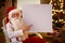 Smiling Santa Claus pointing in empty banner
