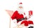 Smiling Santa Claus sitting on a beach chair and holding a gift