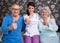 Smiling satisfied elderly people with nurse