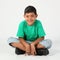 Smiling school boy 9 sitting cross legged on floor