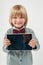 Smiling School boy in shirt with red bow tie, holding tablet computer in white background