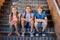 Smiling school kids sitting together on staircase