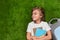 Smiling schoolboy lying on grass and looking away