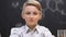 Smiling schoolboy sitting on chemistry lesson, educational laboratory, close-up