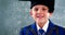 Smiling schoolboy standing in classroom