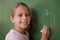 Smiling schoolgirl drawing an apple