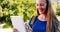 Smiling schoolgirl using digital tablet in campus