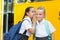 Smiling schoolgirl whispering in her friend\'s ear