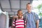 Smiling schoolkids standing in corridor