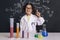 Smiling scientist child in lab coat having an idea