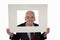 Smiling senior businessman holding a photo mount