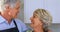 Smiling senior couple interacting with each other in kitchen