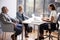 Smiling Senior Couple Meeting With Female Financial Advisor In Office