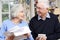 Smiling Senior Couple Reviewing Home Finances