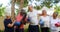 Smiling senior friends holding exercise mat and interacting with each other 4k