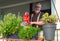 Smiling Senior watering herbs