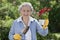 Smiling Senior Woman Holding Flowers