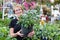 Smiling senior woman holding potted plant