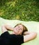 Smiling senior woman lying outdoor