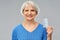 Smiling senior woman with pack of pills