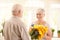 Smiling senior woman receiving bouquet