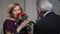 Smiling senior woman receiving flowers from man