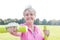 Smiling senior woman with sort hair exercising with weights