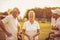 Smiling seniors golfers talking on golf field