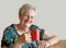 Smiling seventy-something woman with mug
