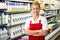 Smiling shop assistant with arms crossed