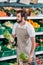 smiling shop assistant arranging fresh vegetables