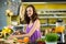 Smiling shop assistant chopping leaf vegetable at counter