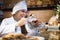 Smiling shopgirl working in bakery with pastry