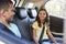 Smiling siblings in the back of a car during a family trip