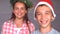 Smiling siblings with christmas hat