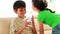 Smiling siblings drinking a glass of milk