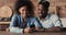 Smiling sincere young african american family couple using smartphone.