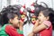 Smiling sisters decorating their hair with Christmas decorations