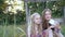 Smiling sisters making selfie sitting on a lawn