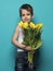 Smiling small boy with yellow tulip . International Womens, Moth