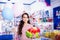 Smiling small girl receives boxes with gifts in the toys shop