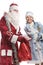 Smiling snow maiden and Santa Claus