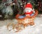 Smiling snowman Santa Toy sitting in a sleigh in winter forest