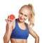 Smiling sport girl holding a half of grapefruit